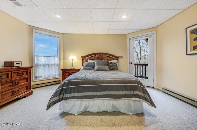 carpeted bedroom with a paneled ceiling, a baseboard radiator, and access to exterior