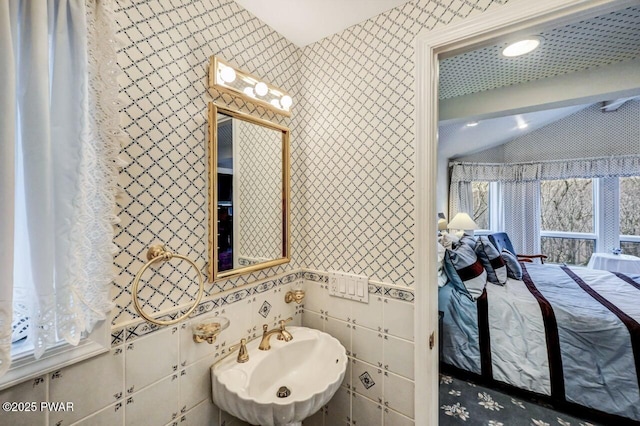 bathroom featuring lofted ceiling and sink