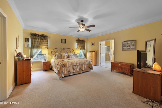bedroom with ceiling fan, light colored carpet, crown molding, baseboards, and ensuite bath