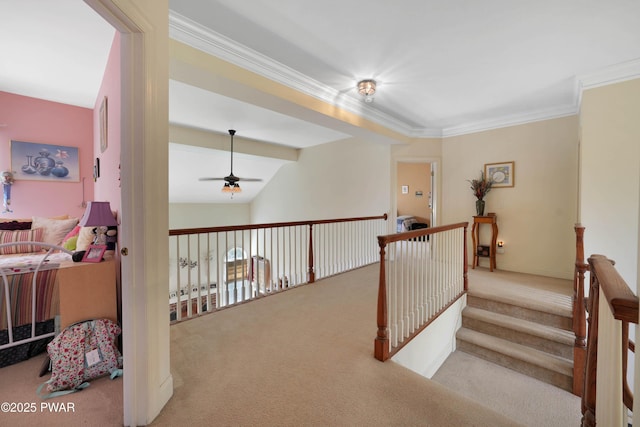 hall featuring carpet floors, ornamental molding, and lofted ceiling