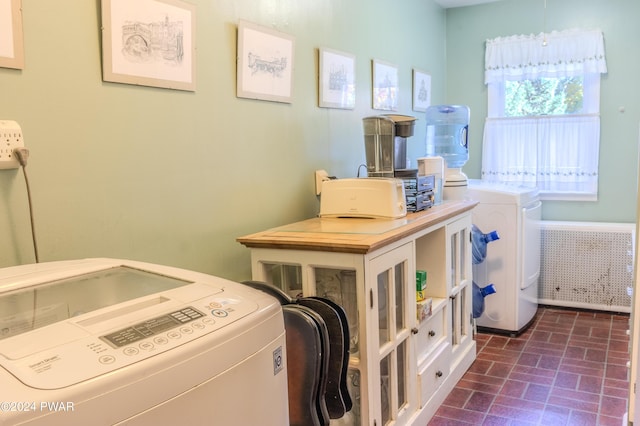 washroom featuring washer and dryer and radiator