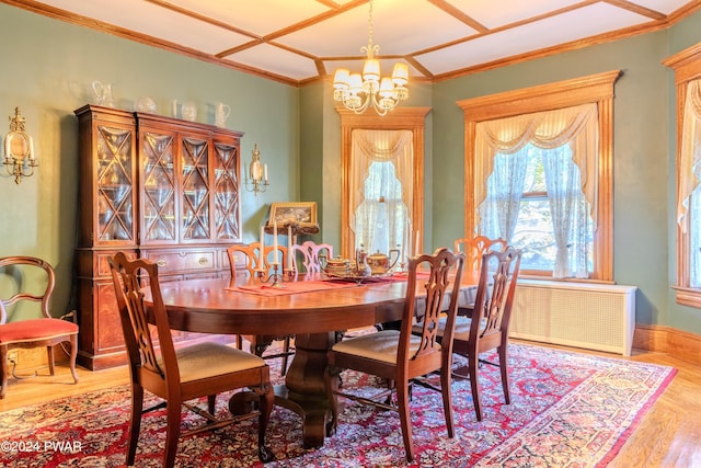 dining space featuring radiator heating unit, wood-type flooring, and a notable chandelier