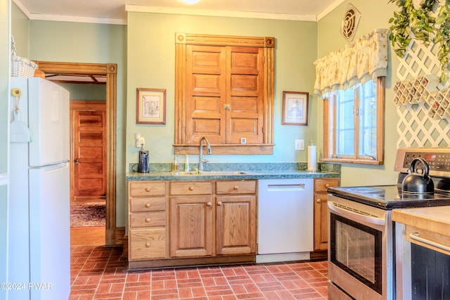 kitchen featuring white appliances, ornamental molding, and sink