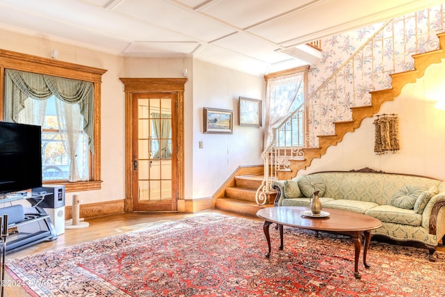 living room featuring wood-type flooring and coffered ceiling