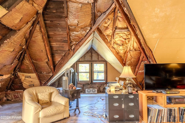 living area featuring hardwood / wood-style flooring and vaulted ceiling