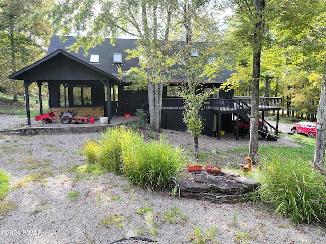 back of house with a wooden deck