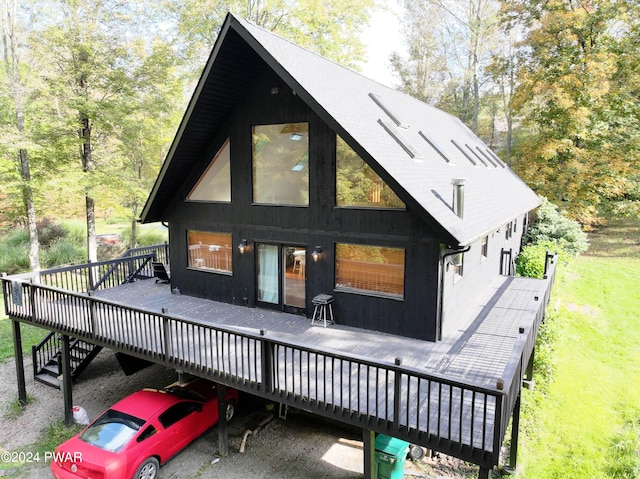 rear view of property featuring a wooden deck