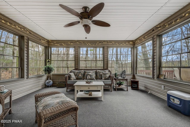 sunroom / solarium with a healthy amount of sunlight and ceiling fan