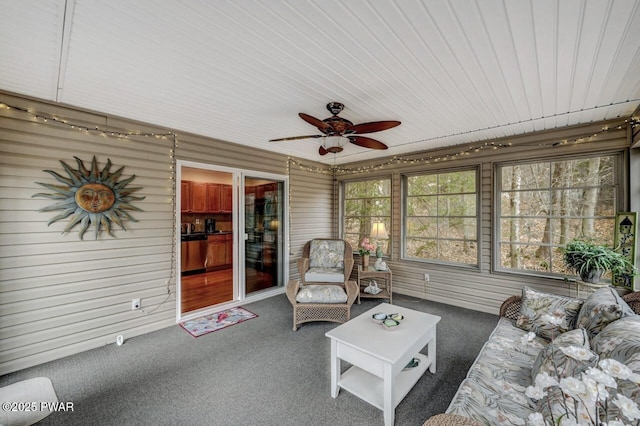 sunroom featuring a ceiling fan