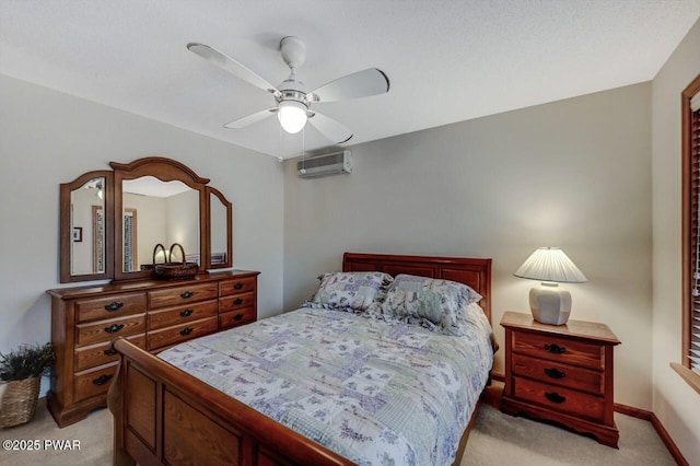 bedroom with baseboards, light colored carpet, a wall mounted air conditioner, and a ceiling fan