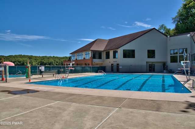 pool featuring a patio area and fence