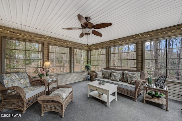 sunroom / solarium with a ceiling fan