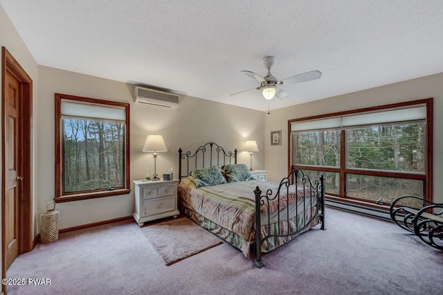 bedroom featuring baseboards, a wall mounted AC, ceiling fan, a textured ceiling, and carpet flooring