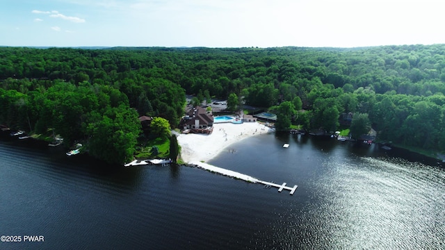 birds eye view of property with a wooded view and a water view