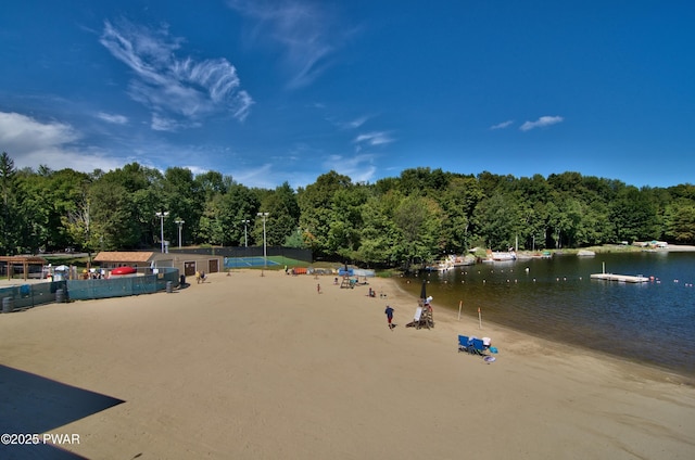 view of community with a water view and a view of trees