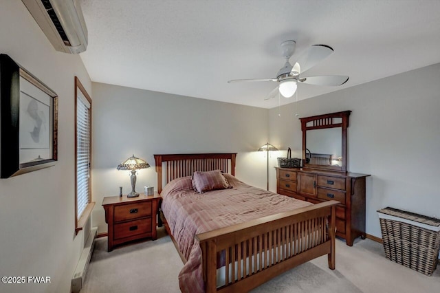 bedroom featuring a baseboard heating unit, baseboards, ceiling fan, light colored carpet, and an AC wall unit