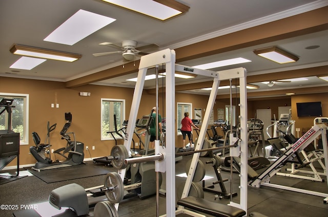 gym with crown molding, a healthy amount of sunlight, baseboards, and ceiling fan