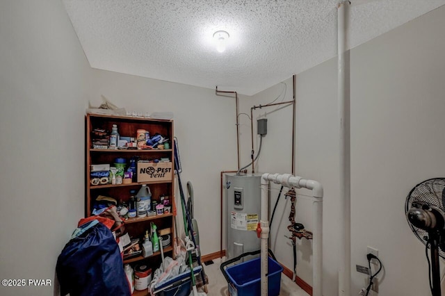 interior space with baseboards, electric water heater, and a textured ceiling