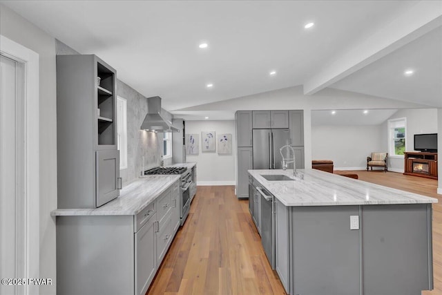 105 Cherry Point Ct, Hawley, PA 18428 - kitchen featuring gray cabinets, wall chimney range hood, stainless steel appliances, a sink, and light wood-style flooring