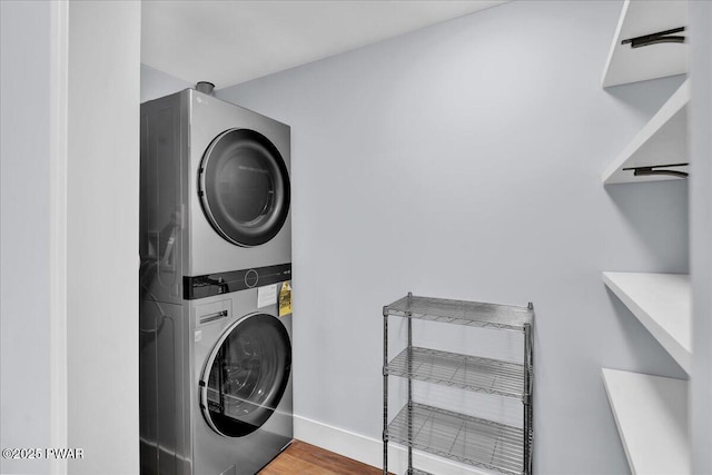 105 Cherry Point Ct, Hawley, PA 18428 - laundry room with stacked washer / dryer, wood finished floors, and baseboards