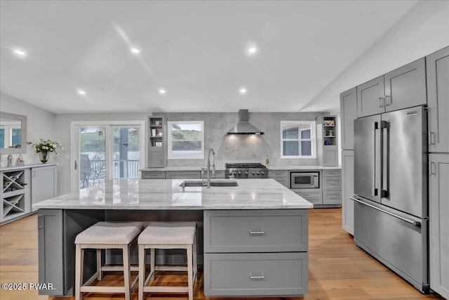 105 Cherry Point Ct, Hawley, PA 18428 - kitchen featuring stainless steel appliances, gray cabinetry, wall chimney exhaust hood, a sink, and light stone countertops