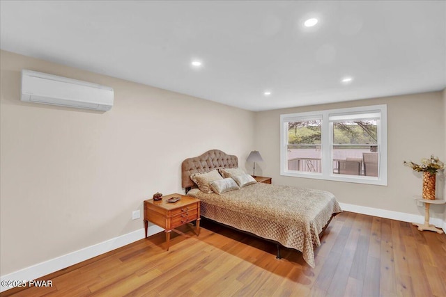 105 Cherry Point Ct, Hawley, PA 18428 - bedroom featuring a wall mounted AC, baseboards, recessed lighting, and wood finished floors