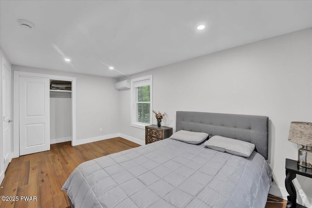 105 Cherry Point Ct, Hawley, PA 18428 - bedroom with a wall unit AC, baseboards, wood finished floors, a closet, and recessed lighting