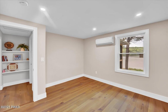 105 Cherry Point Ct, Hawley, PA 18428 - basement featuring a wall mounted AC, wood finished floors, baseboards, and recessed lighting