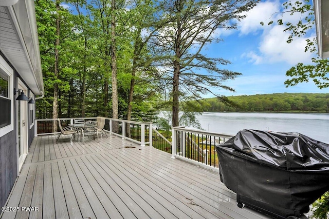 105 Cherry Point Ct, Hawley, PA 18428 - deck with outdoor dining area, a water view, area for grilling, and a forest view