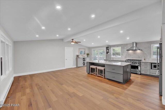 105 Cherry Point Ct, Hawley, PA 18428 - kitchen featuring appliances with stainless steel finishes, gray cabinets, wall chimney range hood, light countertops, and a kitchen island with sink