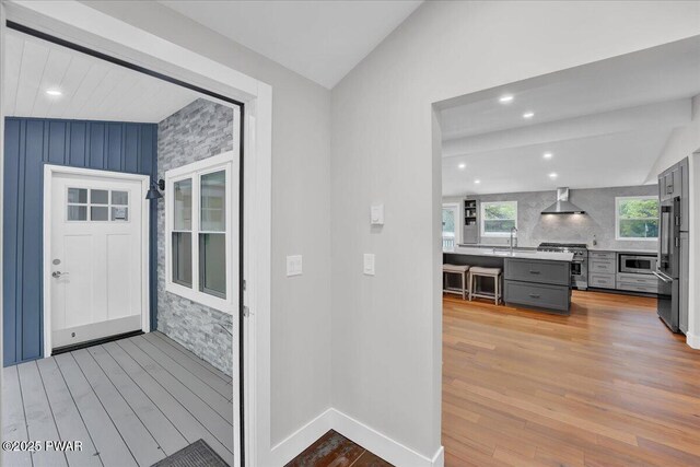 105 Cherry Point Ct, Hawley, PA 18428 - corridor featuring light wood finished floors, lofted ceiling, a sink, recessed lighting, and baseboards