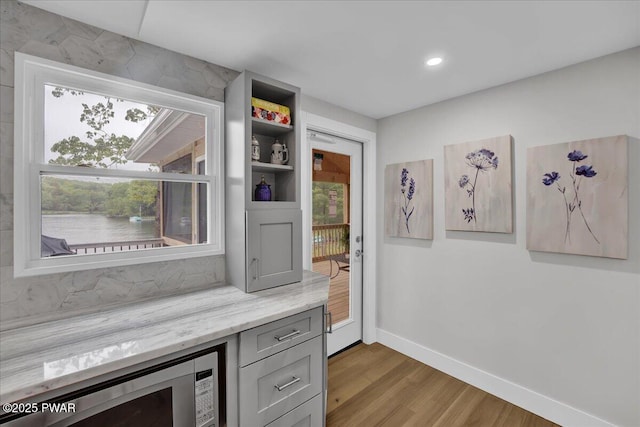 105 Cherry Point Ct, Hawley, PA 18428 - bar featuring wood finished floors, baseboards, stainless steel microwave, and recessed lighting