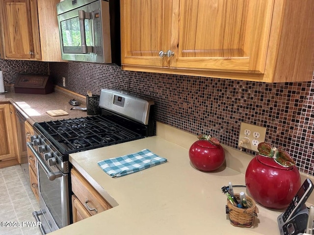 106 Chestnut Dr, Greentown, PA 18426 - kitchen featuring appliances with stainless steel finishes, backsplash, and light countertops