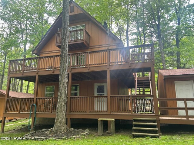 106 Chestnut Dr, Greentown, PA 18426 - rear view of property featuring a wooden deck, stairs, and an outdoor structure