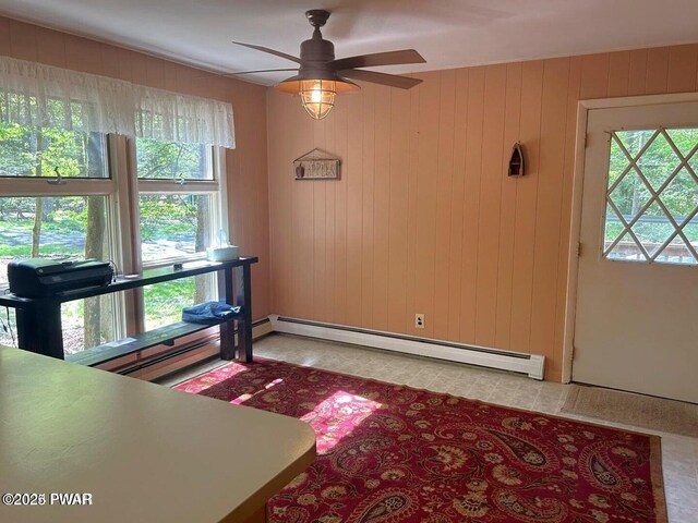 106 Chestnut Dr, Greentown, PA 18426 - entrance foyer with a baseboard radiator, a ceiling fan, and wooden walls