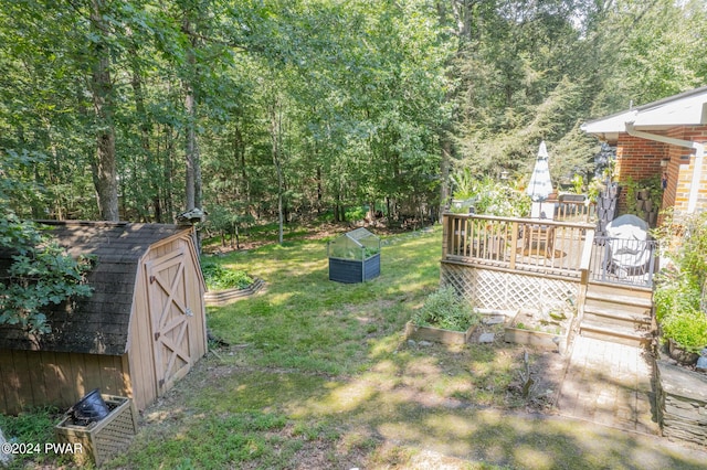 view of yard featuring a storage shed and a wooden deck