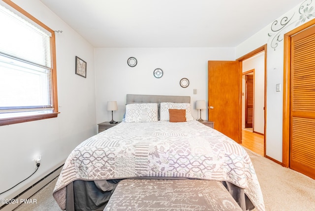 bedroom featuring carpet and a baseboard heating unit