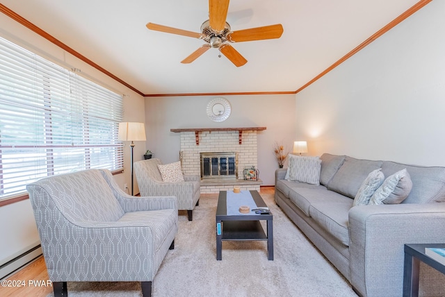 living room with a brick fireplace, a wealth of natural light, a baseboard heating unit, and ceiling fan