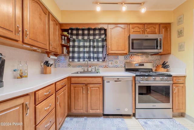 kitchen featuring appliances with stainless steel finishes, backsplash, and sink