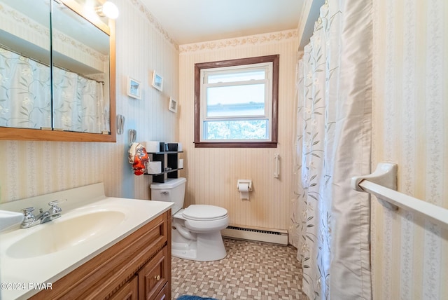 bathroom with vanity, toilet, and a baseboard radiator