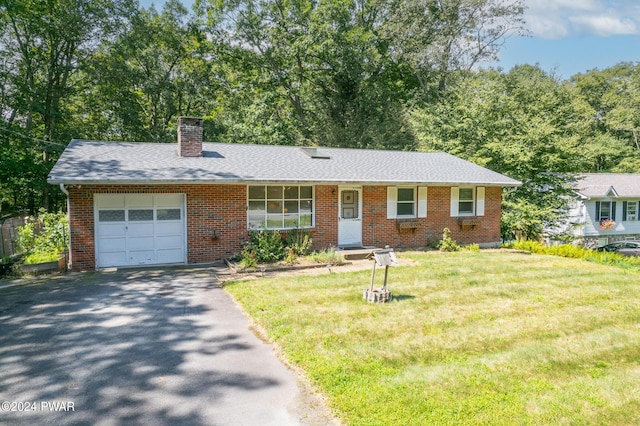 single story home with a front yard and a garage