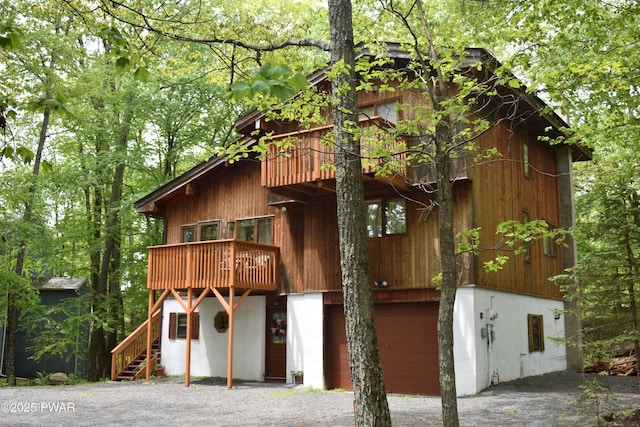 404 Canoebrook Dr, Lords Valley, PA 18428 - view of front facade with a garage, a balcony, and stairs