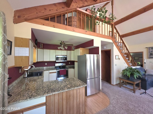 1304 Pratt Hollow Rd, Nicholson, PA 18446 - kitchen featuring stainless steel appliances, a sink, beamed ceiling, a ceiling fan, and dark stone countertops