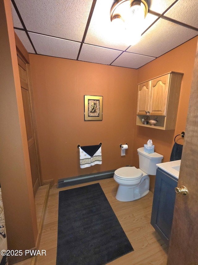 1304 Pratt Hollow Rd, Nicholson, PA 18446 - bathroom featuring toilet, wood finished floors, vanity, and a paneled ceiling