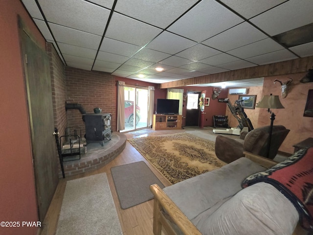 1304 Pratt Hollow Rd, Nicholson, PA 18446 - living room featuring a wood stove, light wood-type flooring, and a drop ceiling