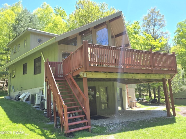 1304 Pratt Hollow Rd, Nicholson, PA 18446 - rear view of property featuring a deck, a lawn, stairs, and a carport