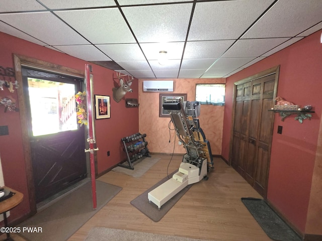 1304 Pratt Hollow Rd, Nicholson, PA 18446 - exercise area featuring a wall unit AC, light wood finished floors, and a drop ceiling