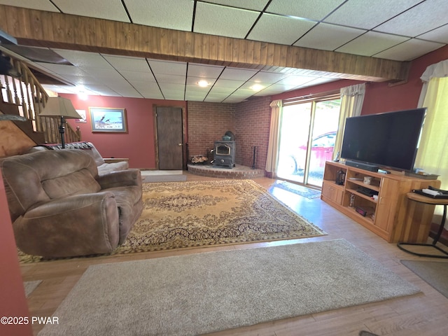 1304 Pratt Hollow Rd, Nicholson, PA 18446 - living room with a wood stove, a paneled ceiling, and wood finished floors