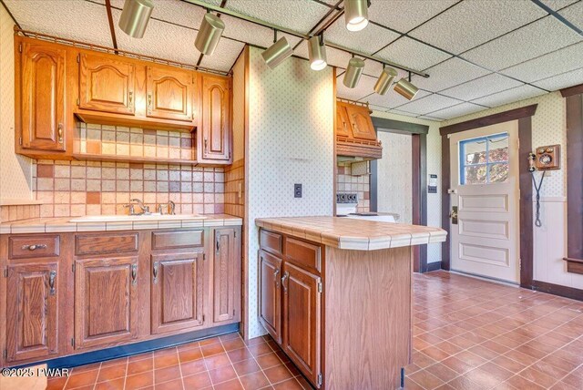 1409 Beach Lake Hwy, Beach Lake, PA 18405 - kitchen featuring a sink, tile patterned floors, tile countertops, and wallpapered walls