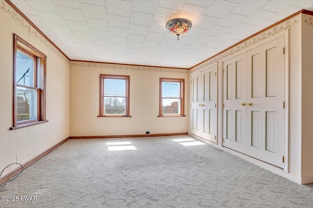 1409 Beach Lake Hwy, Beach Lake, PA 18405 - unfurnished bedroom featuring baseboards, ornamental molding, carpet, and two closets